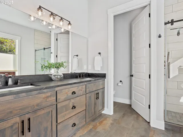 a spacious bathroom with a granite countertop sink a mirror and a