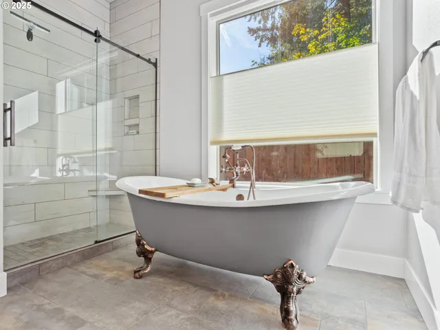 a bathroom with a sink and mirror with bathtub
