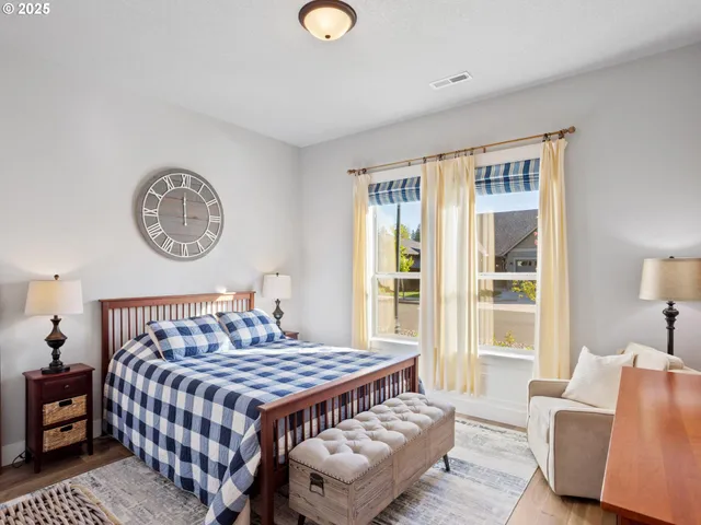 a bedroom with a bed couch and a window