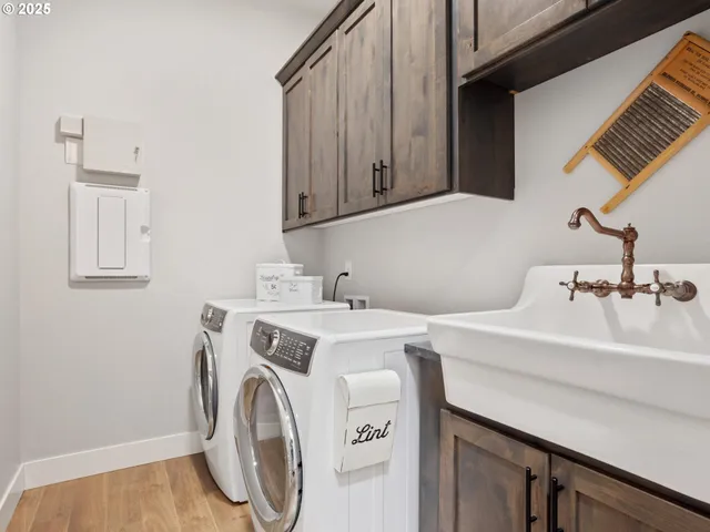 a utility room with sink dryer and washer