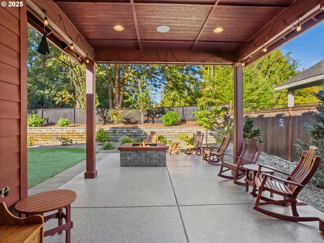 a view of a patio with a table chairs and a backyard