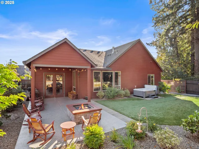 a front view of a house with a yard and outdoor seating