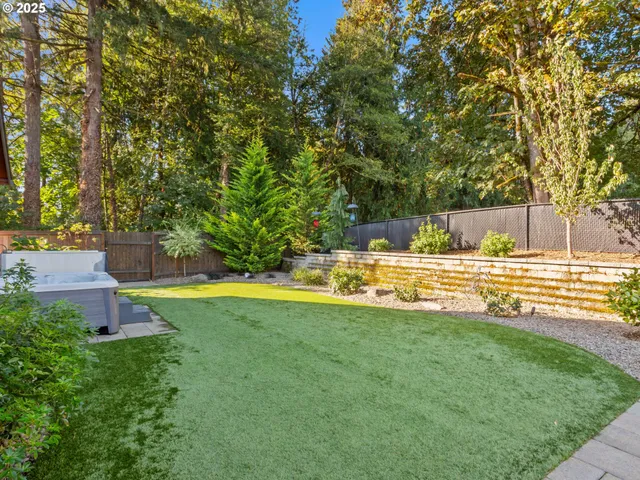 a view of yard with swimming pool and trees