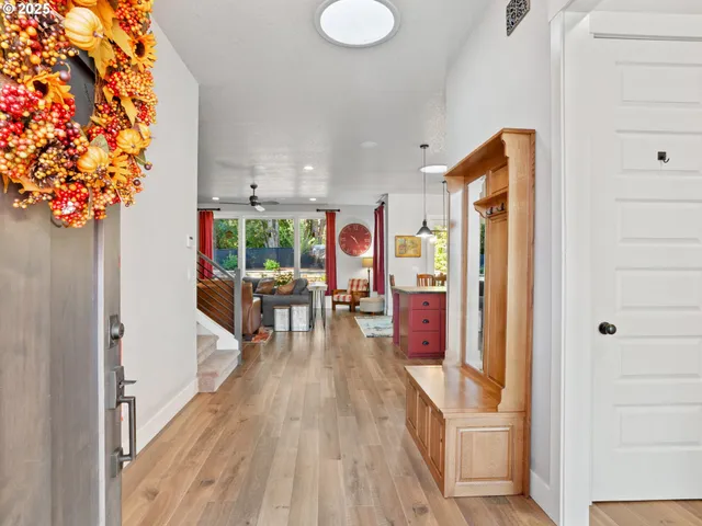 a very nice looking room with a large window and wooden floor