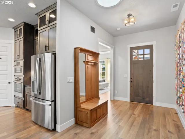 a kitchen with stainless steel appliances granite countertop a refrigerator and a refrigerator