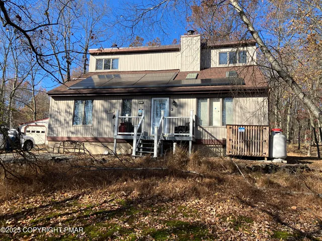 a view of a house with a large window and a fireplace