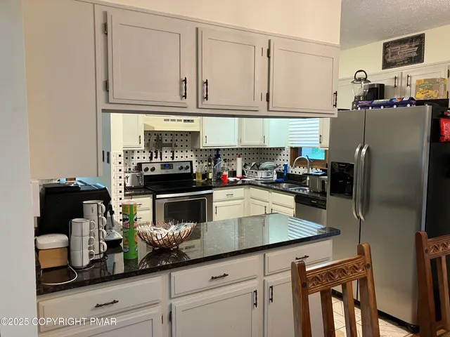 a view of a hallway with wooden floor and stairs