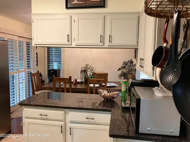 a kitchen with a stove and white cabinets