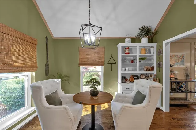 a living room with furniture chandelier and a window