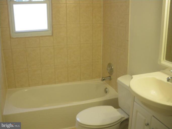 7407 Loisdale Road Springfield, VA 22150 - Photo 22 of 24 a bathroom with a sink toilet and bathtub