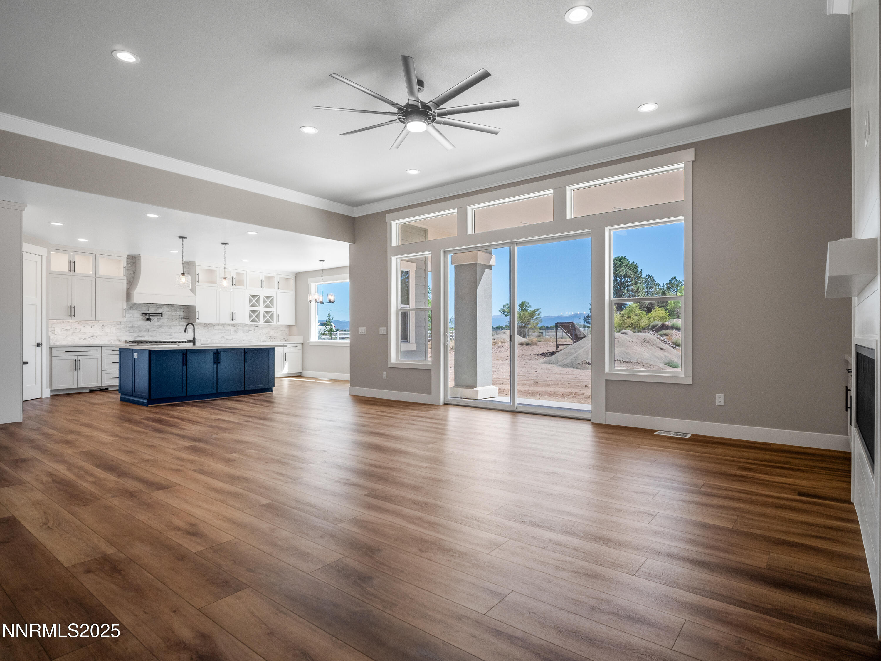 781 Rubio Way Gardnerville, NV 89460 - Photo 11 of 61 a view of an empty room with window and wooden floor