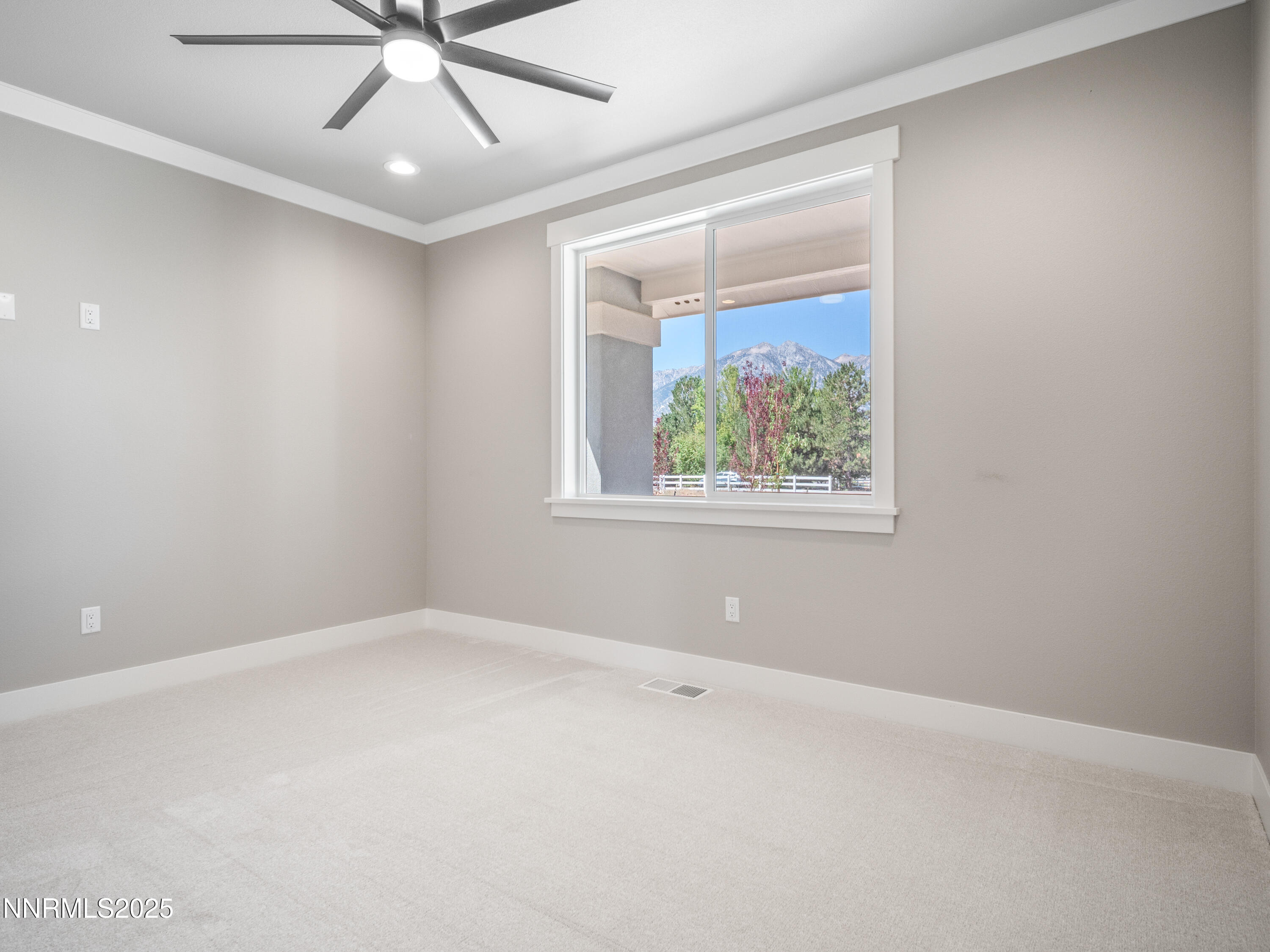781 Rubio Way Gardnerville, NV 89460 - Photo 37 of 61 an empty room with a window and a ceiling fan