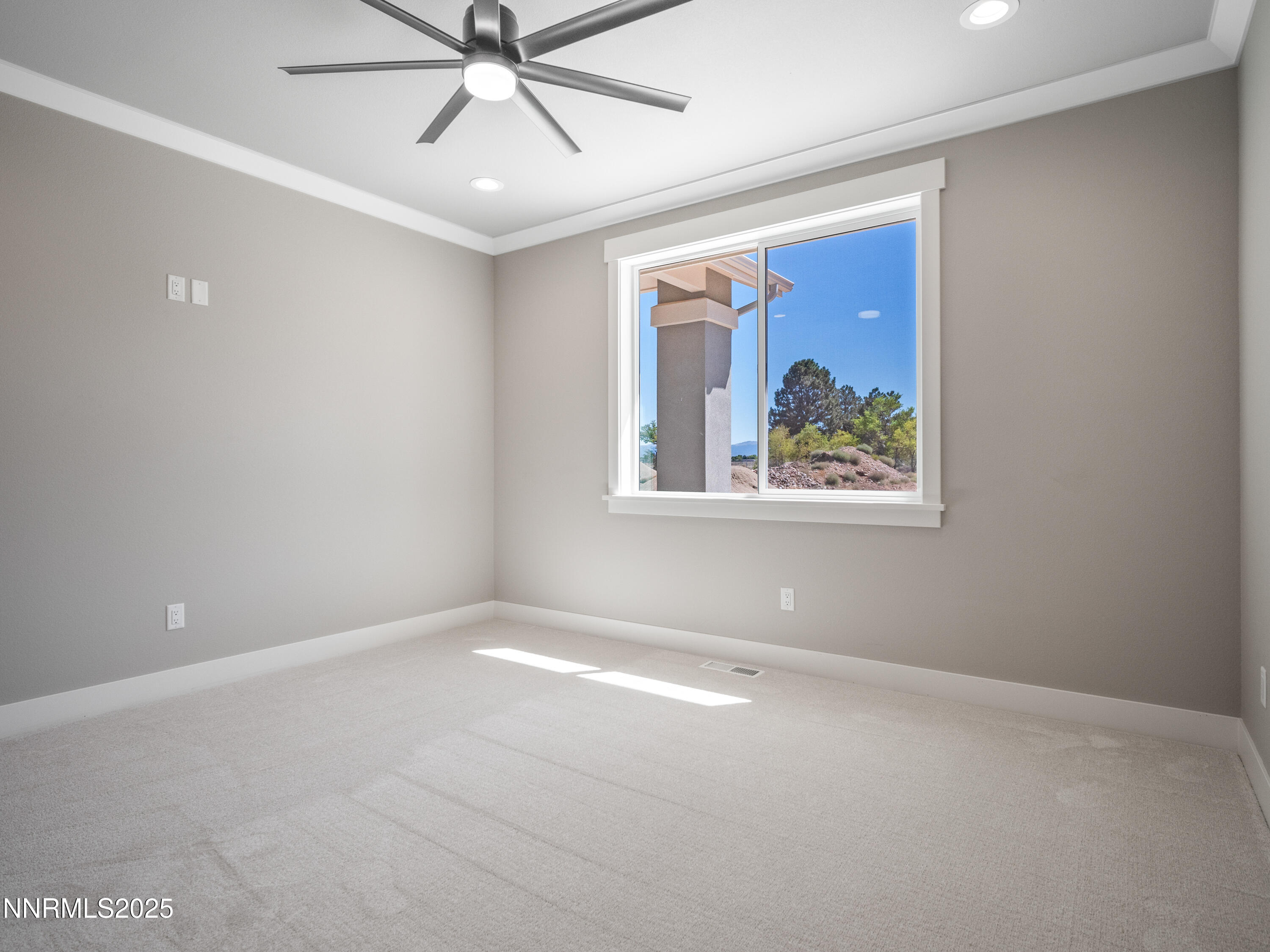 781 Rubio Way Gardnerville, NV 89460 - Photo 4 of 61 an empty room with a window and a fan