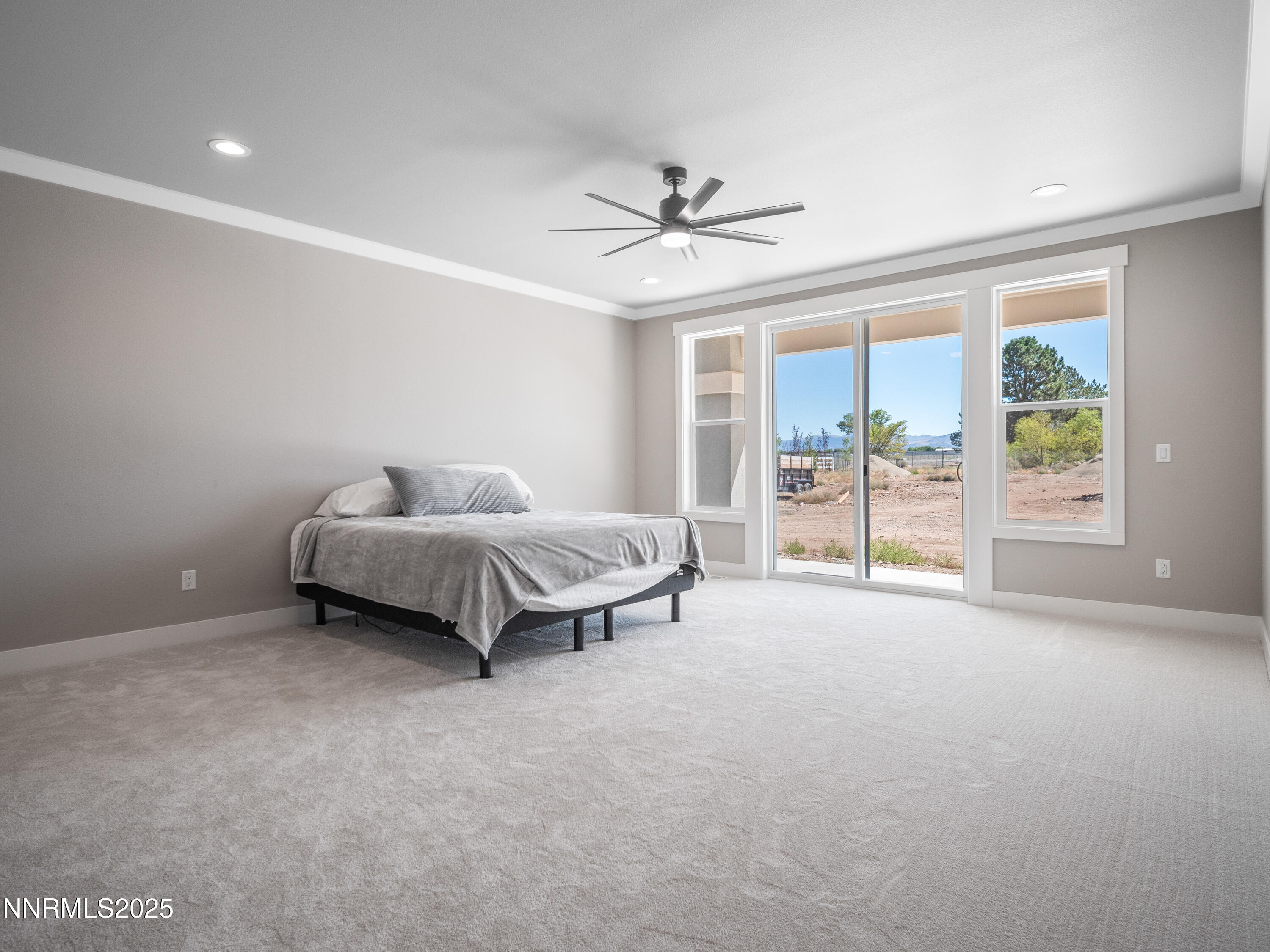 781 Rubio Way Gardnerville, NV 89460 - Photo 44 of 61 a spacious bedroom with a bed and glass door