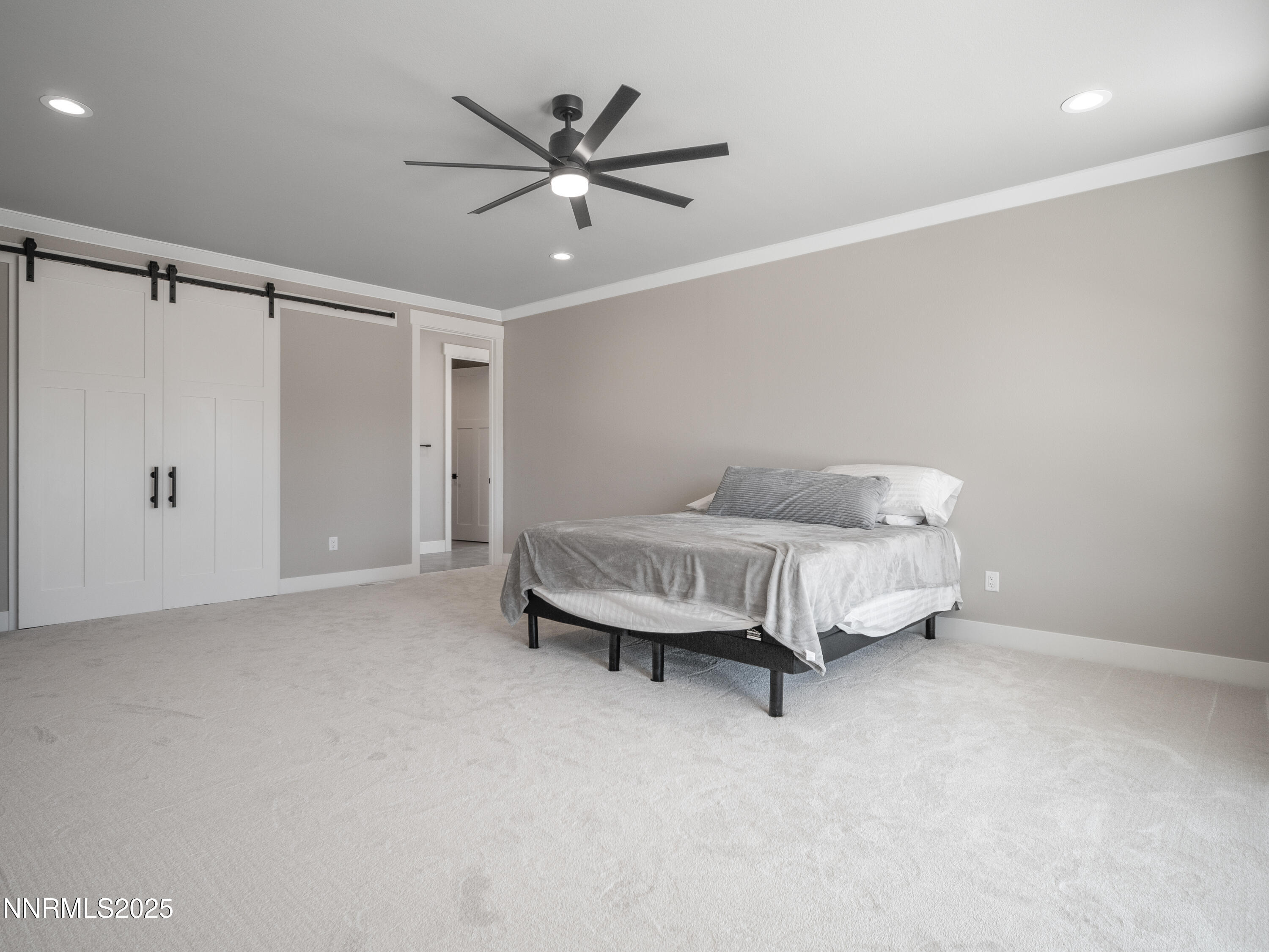 781 Rubio Way Gardnerville, NV 89460 - Photo 45 of 61 a spacious bedroom with a bed and a chandelier