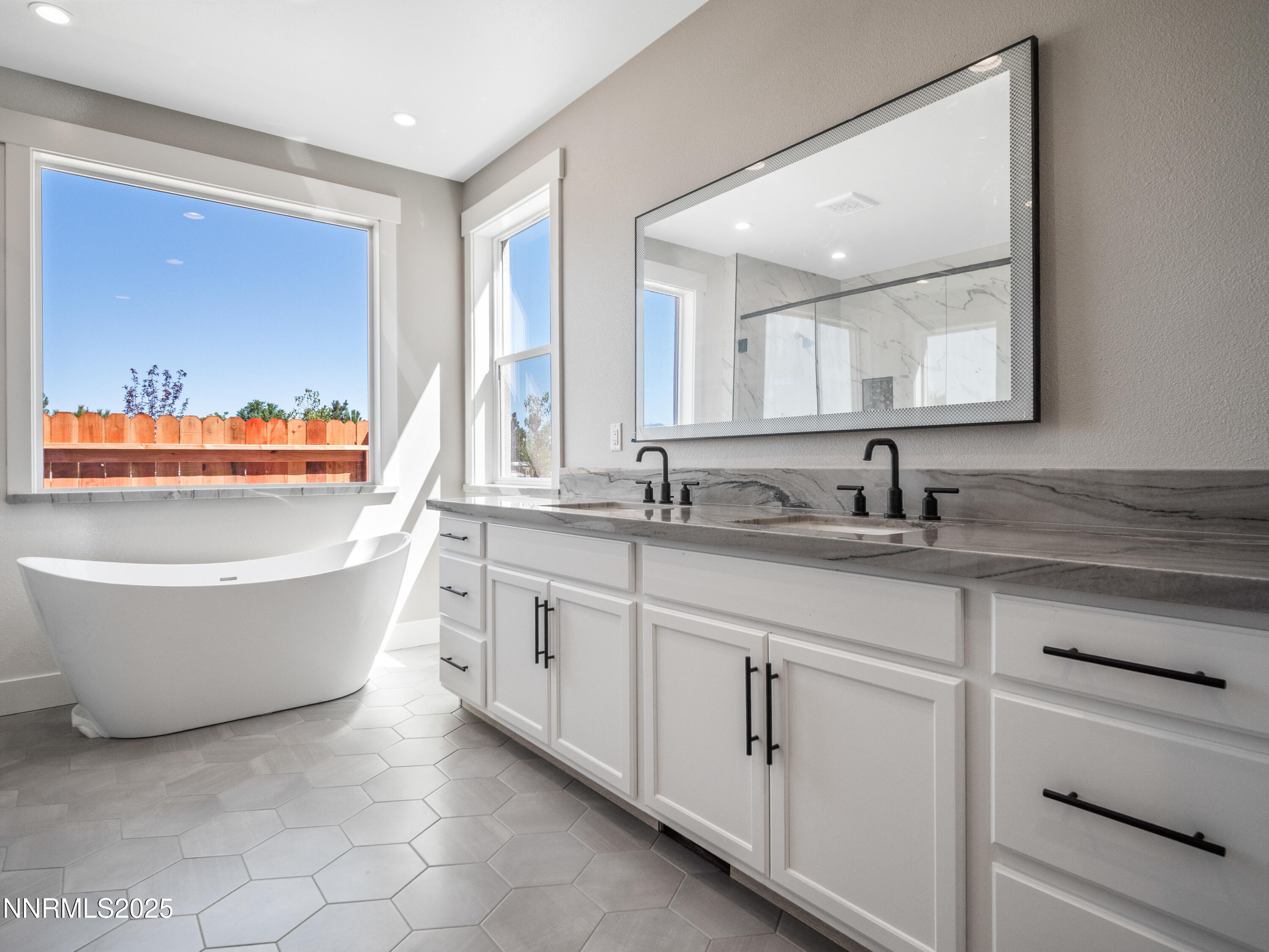 781 Rubio Way Gardnerville, NV 89460 - Photo 48 of 61 a large white bathroom with a sink and a large mirror