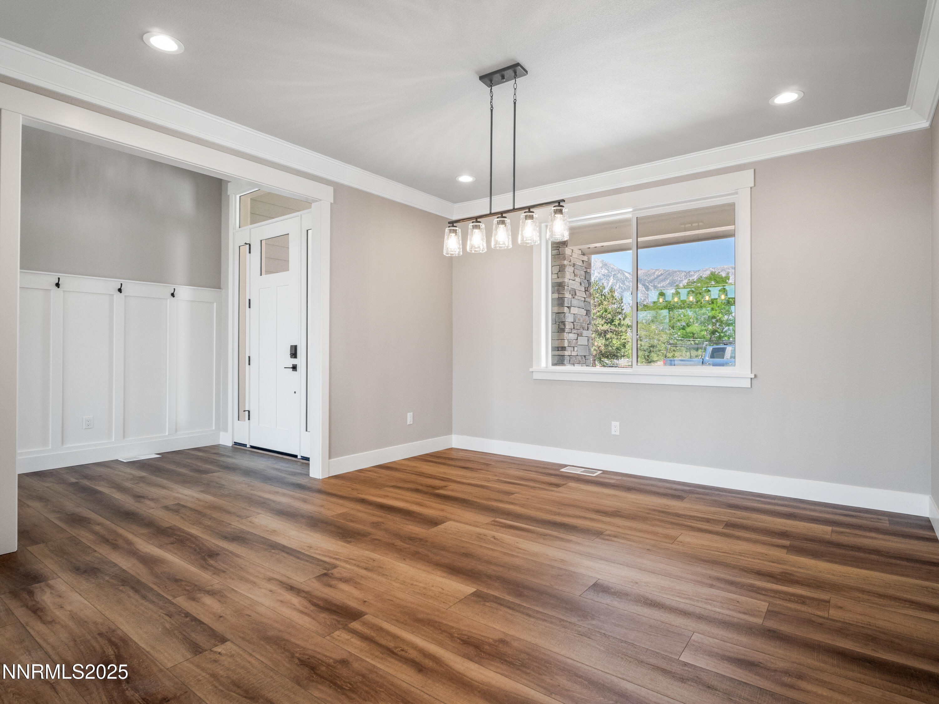 781 Rubio Way Gardnerville, NV 89460 - Photo 5 of 61 a view of an empty room with wooden floor ceiling fan and window