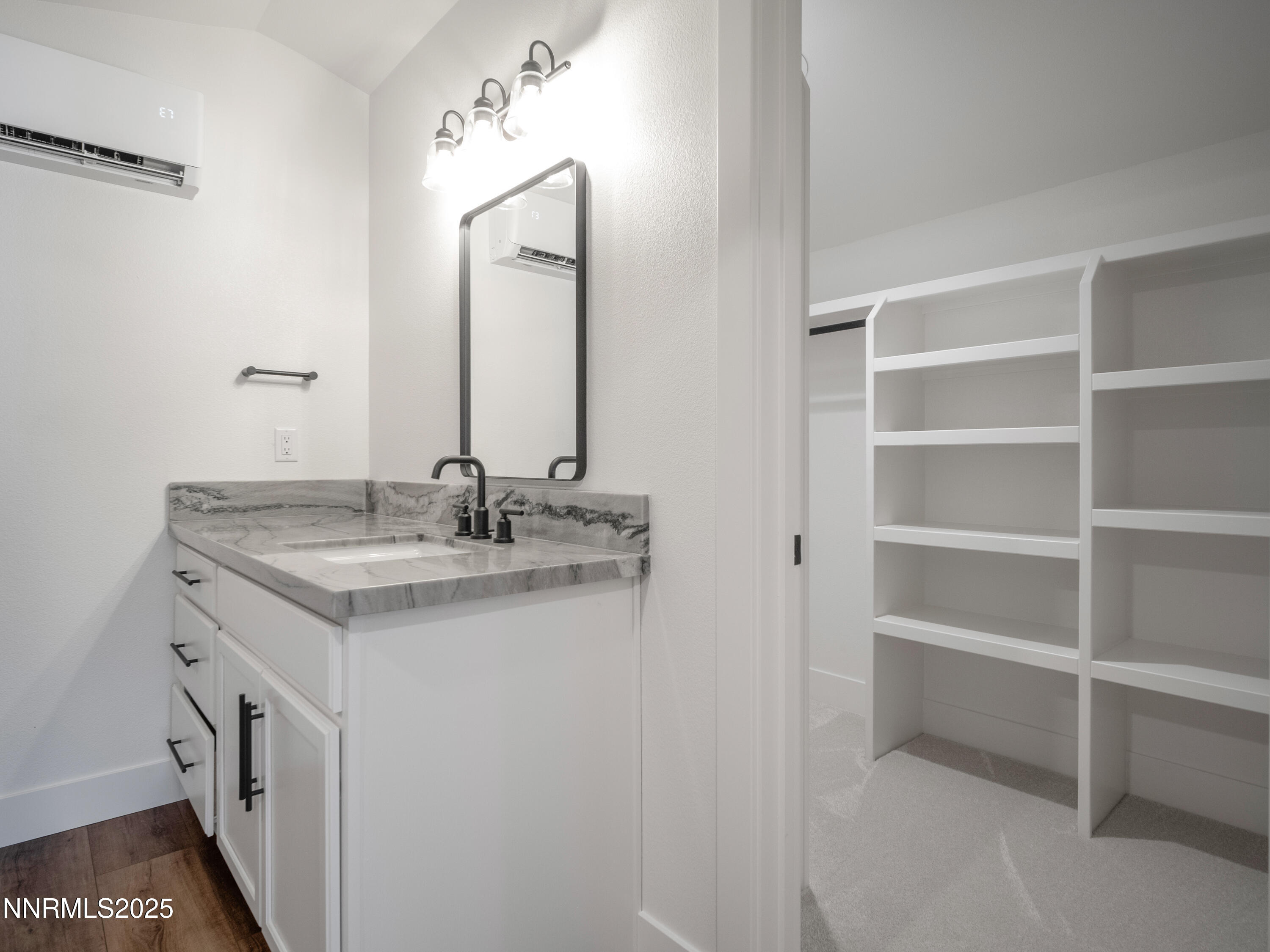 781 Rubio Way Gardnerville, NV 89460 - Photo 58 of 61 a bathroom with a granite countertop sink and a mirror