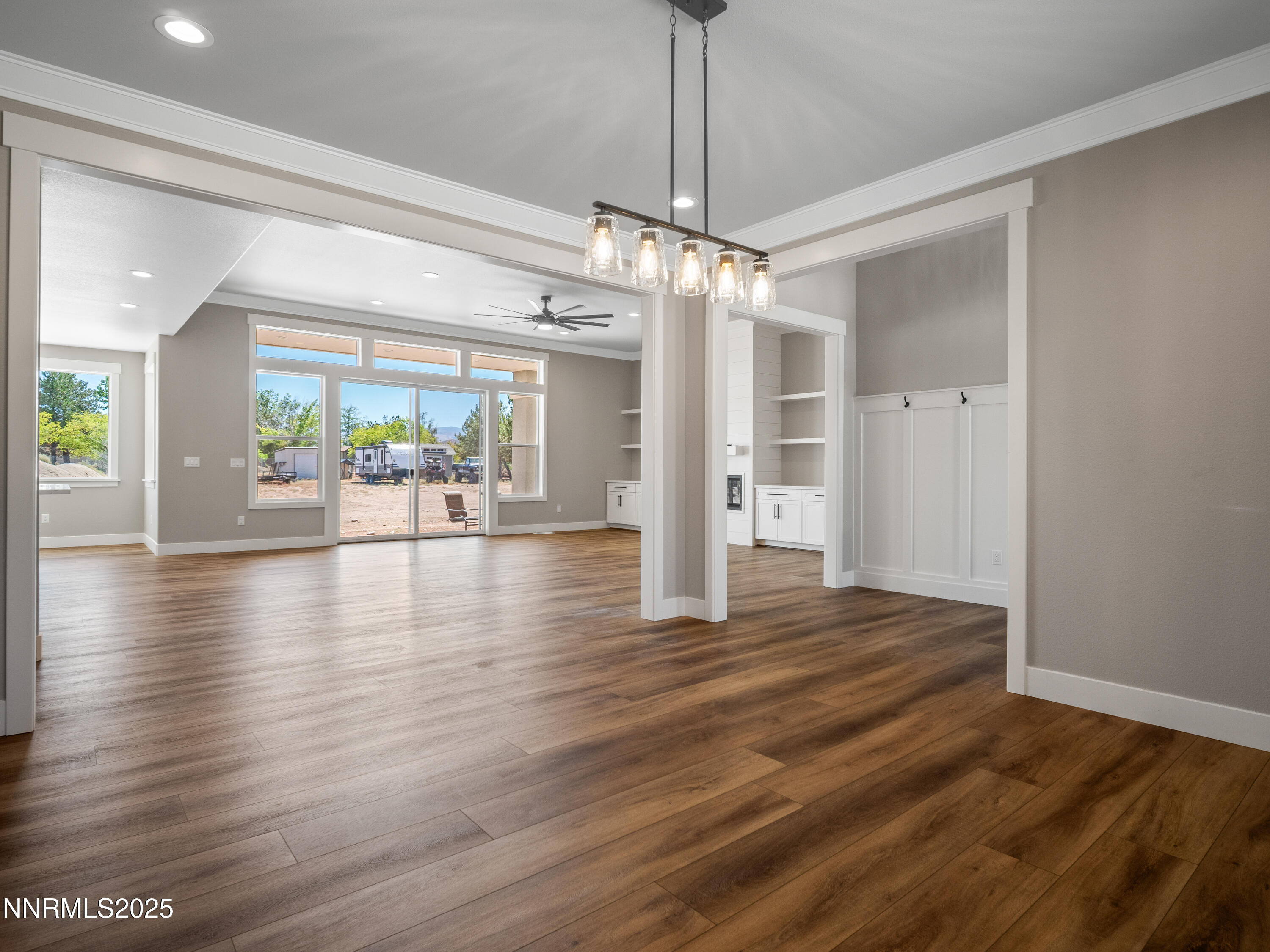 781 Rubio Way Gardnerville, NV 89460 - Photo 6 of 61 a view of a livingroom with wooden floor a ceiling fan and kitchen space