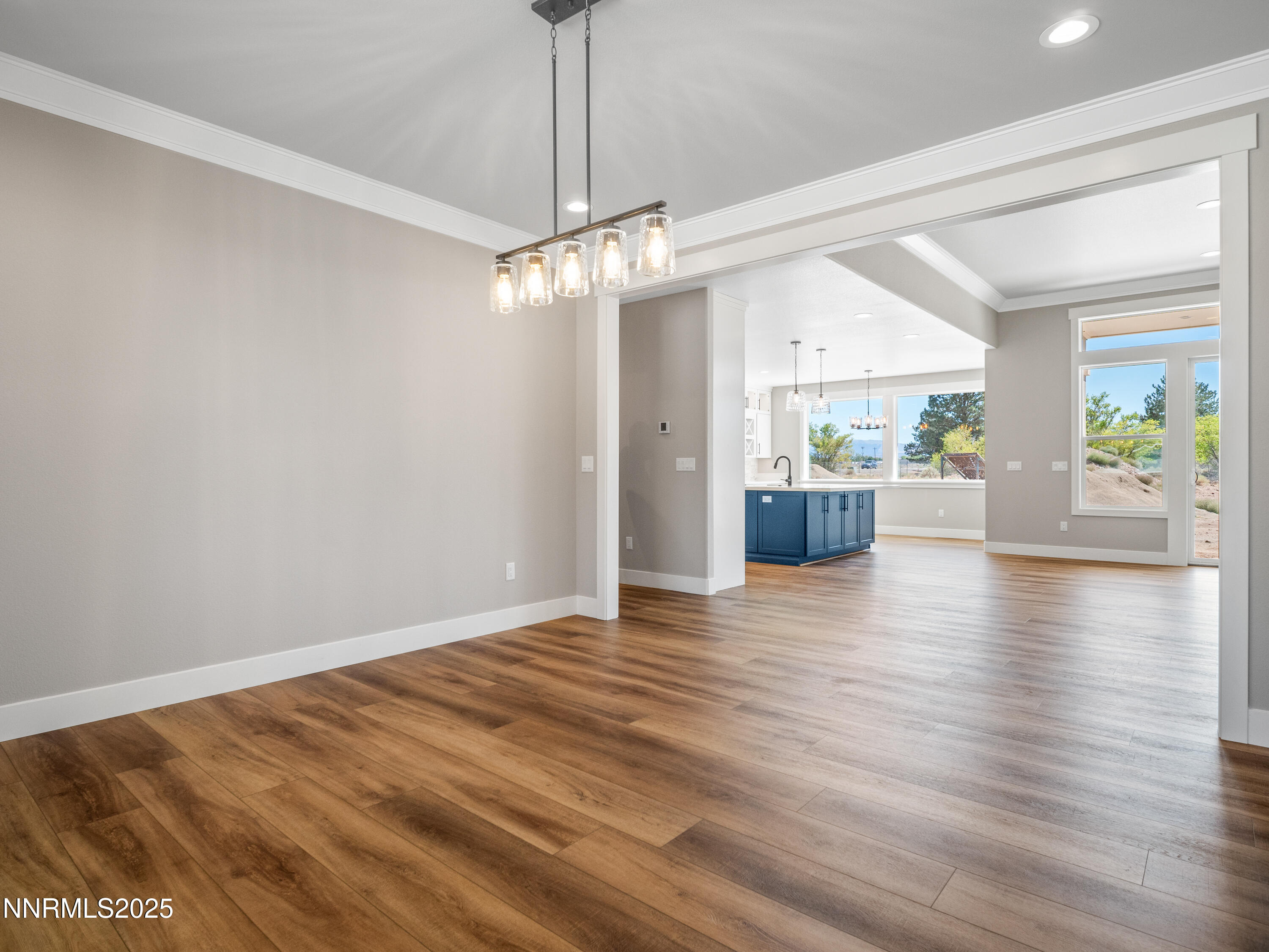 781 Rubio Way Gardnerville, NV 89460 - Photo 7 of 61 a view of an empty room with a window and wooden floor
