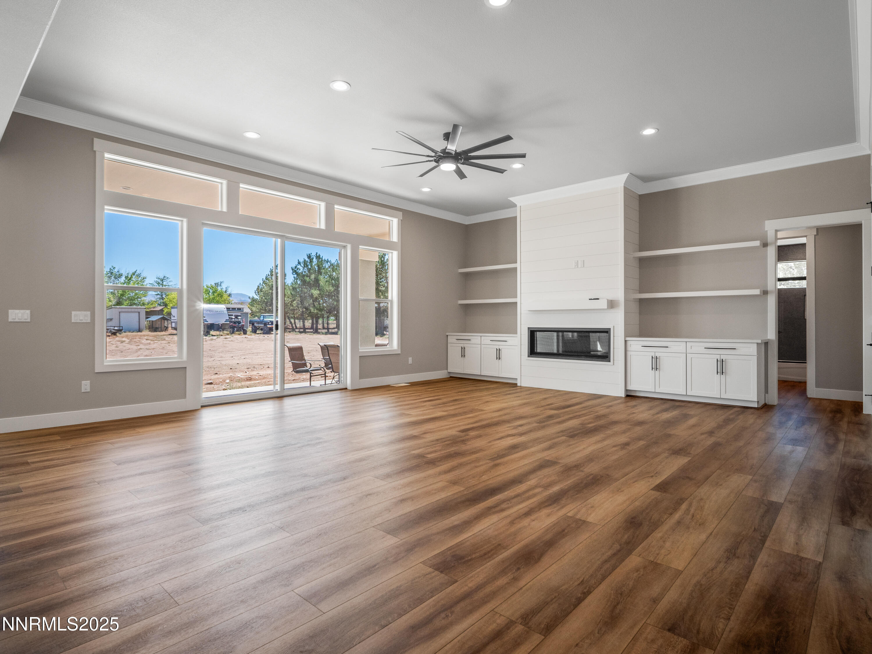 781 Rubio Way Gardnerville, NV 89460 - Photo 8 of 61 a view of empty room with wooden floor and fireplace