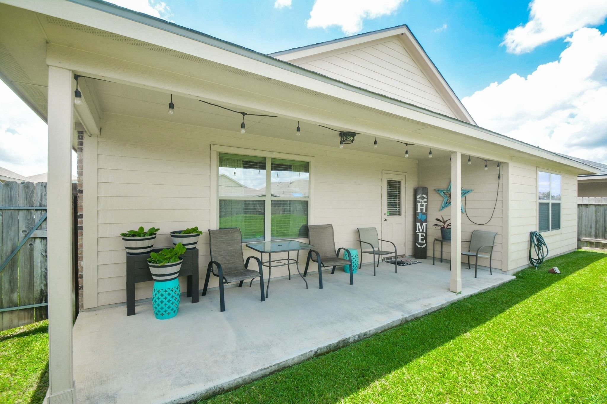 23318 Dukes Run Drive Spring, TX 77373 - Photo 5 of 41 This inviting backyard features a covered patio with room for outdoor seating. The space is perfect for relaxing or entertaining, with a well-maintained lawn and privacy fence.