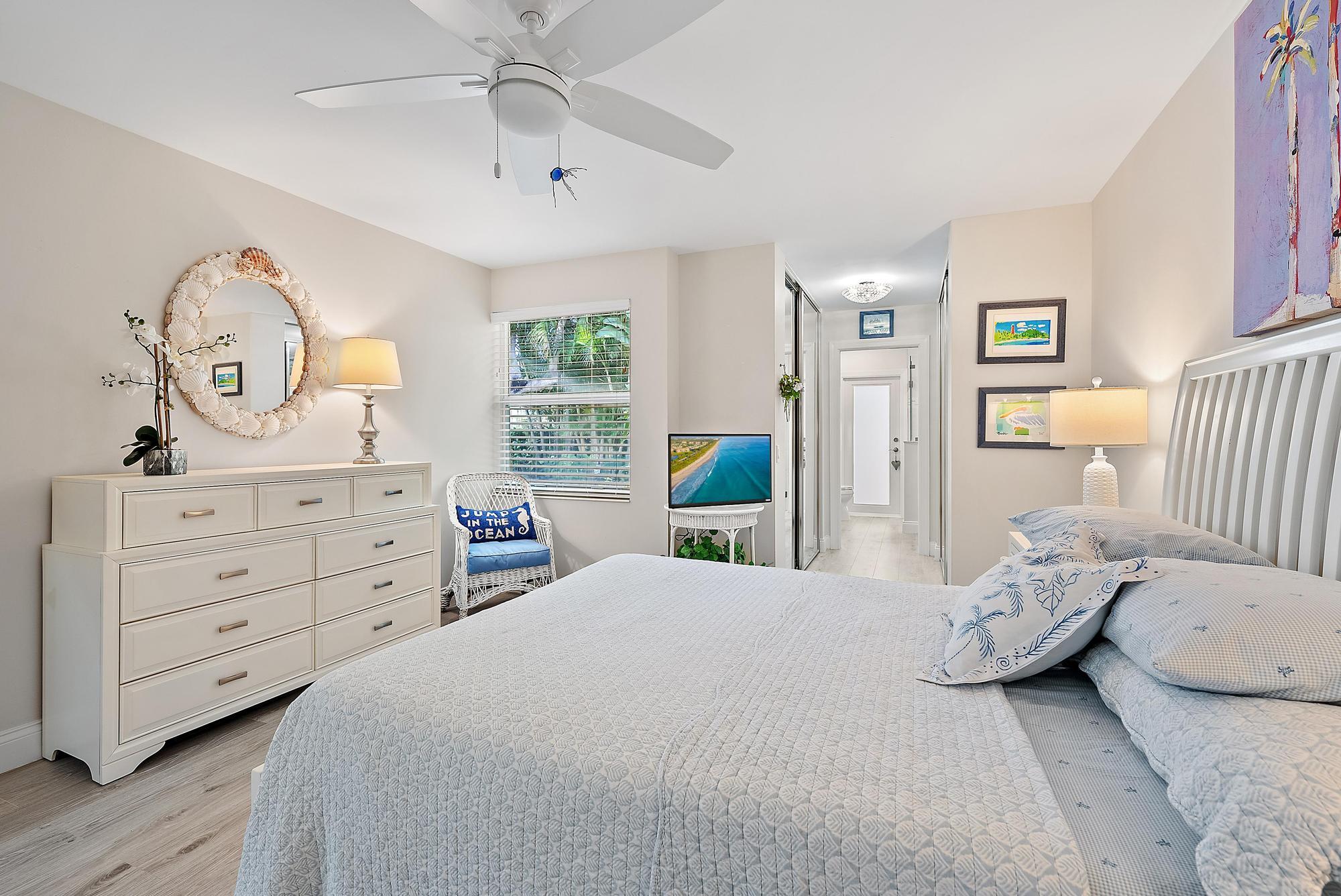197 Brier Circle Jupiter, FL 33458 - Photo 12 of 33 a bedroom with a bed and a chandelier