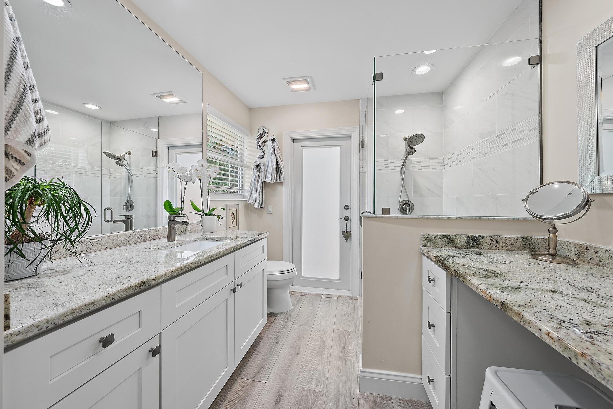 197 Brier Circle Jupiter, FL 33458 - Photo 13 of 33 a bathroom with a granite countertop sink double vanity and a shower
