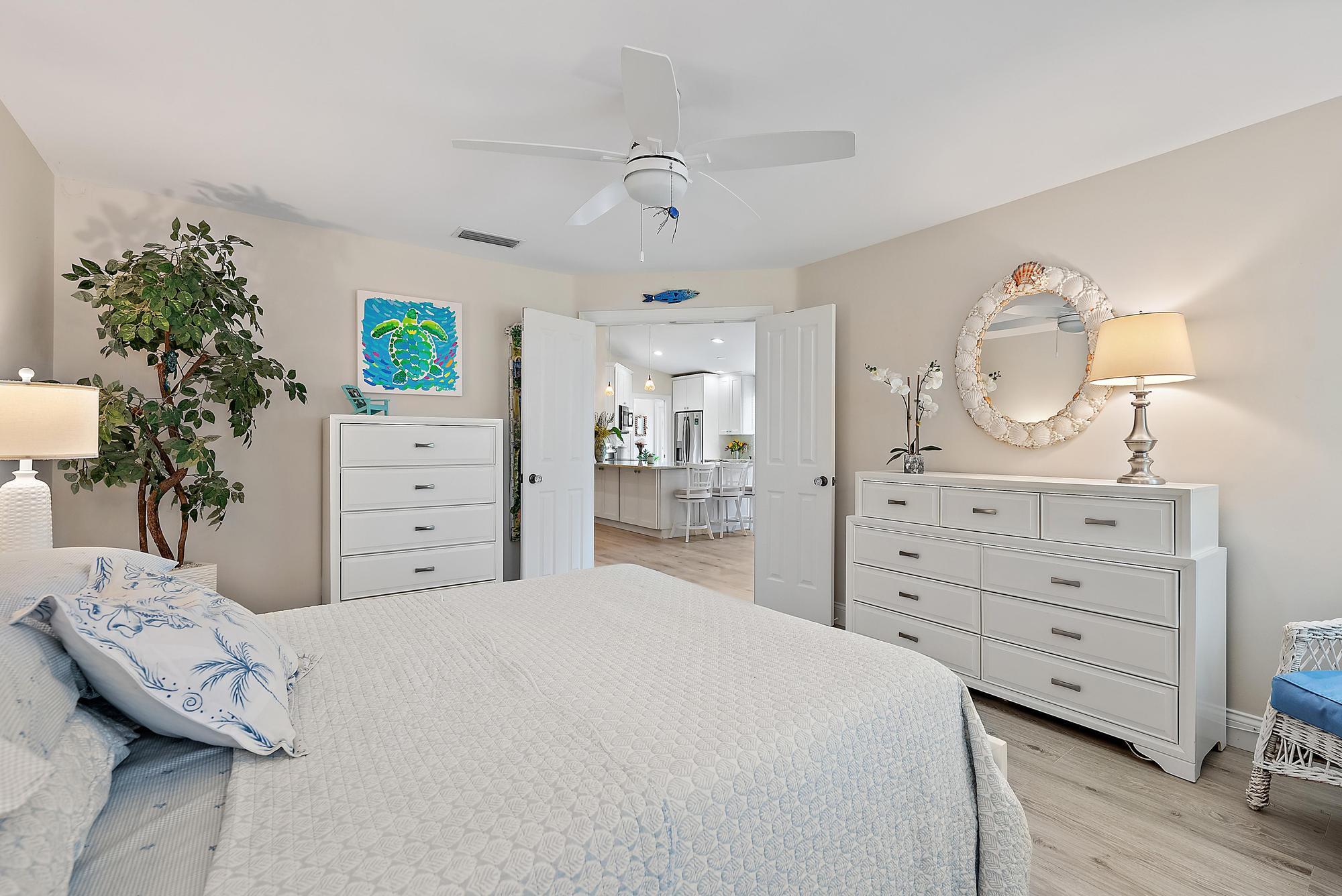 197 Brier Circle Jupiter, FL 33458 - Photo 15 of 33 a bedroom with a bed and a dresser