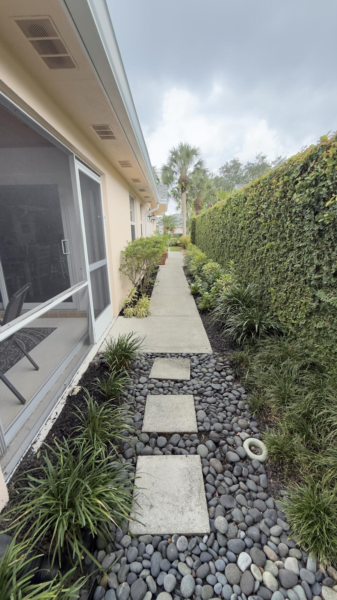 197 Brier Circle Jupiter, FL 33458 - Photo 24 of 33 a view of a pathway along the house