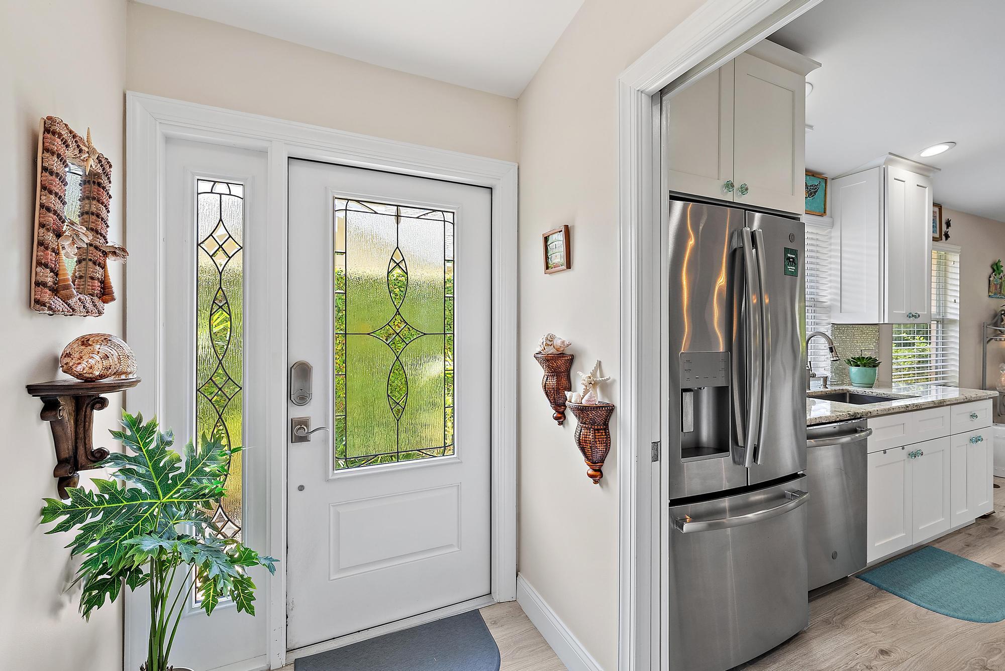 197 Brier Circle Jupiter, FL 33458 - Photo 3 of 33 a kitchen with stainless steel appliances a refrigerator and a plant