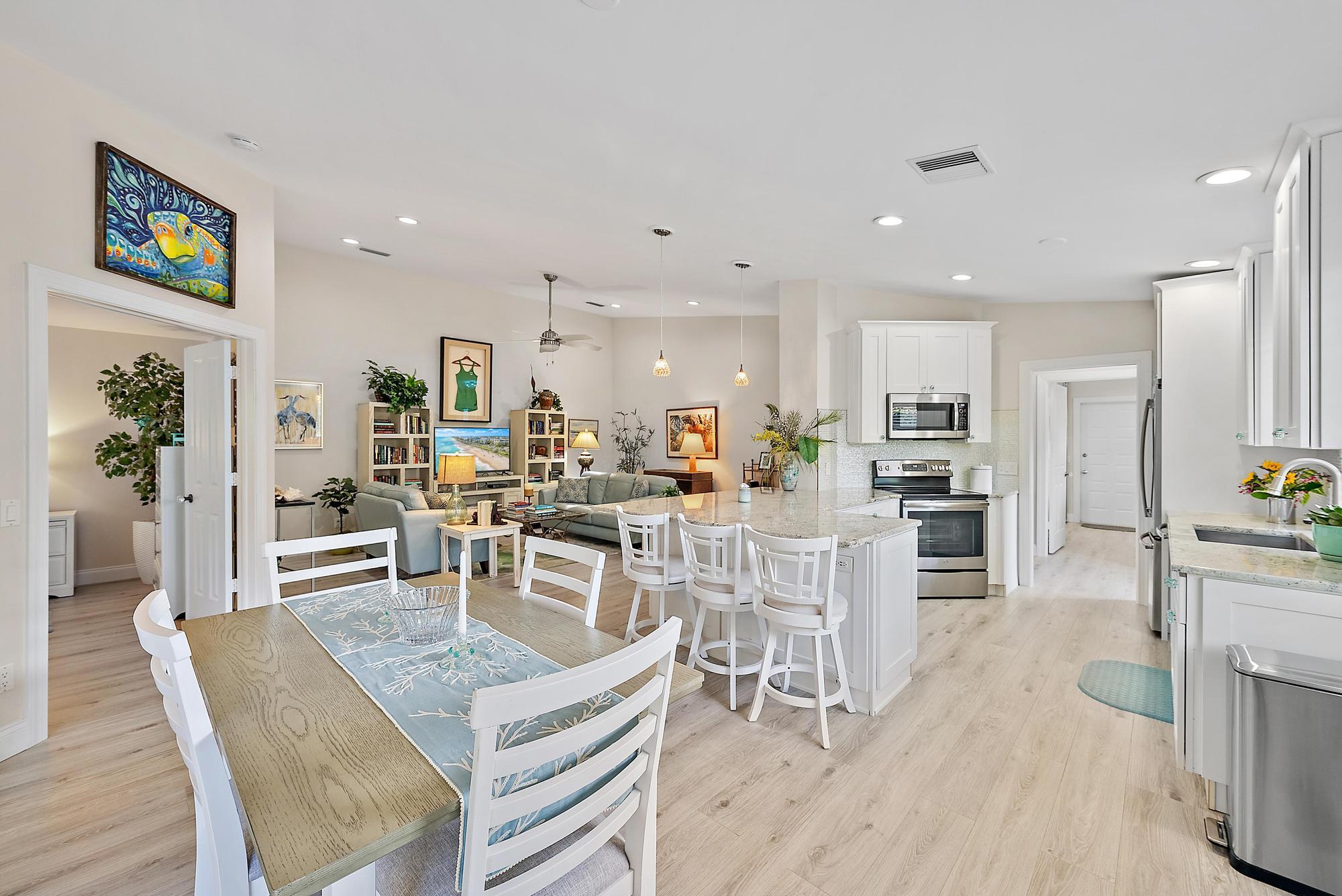 197 Brier Circle Jupiter, FL 33458 - Photo 6 of 33 a view of a dining room with furniture and wooden floor