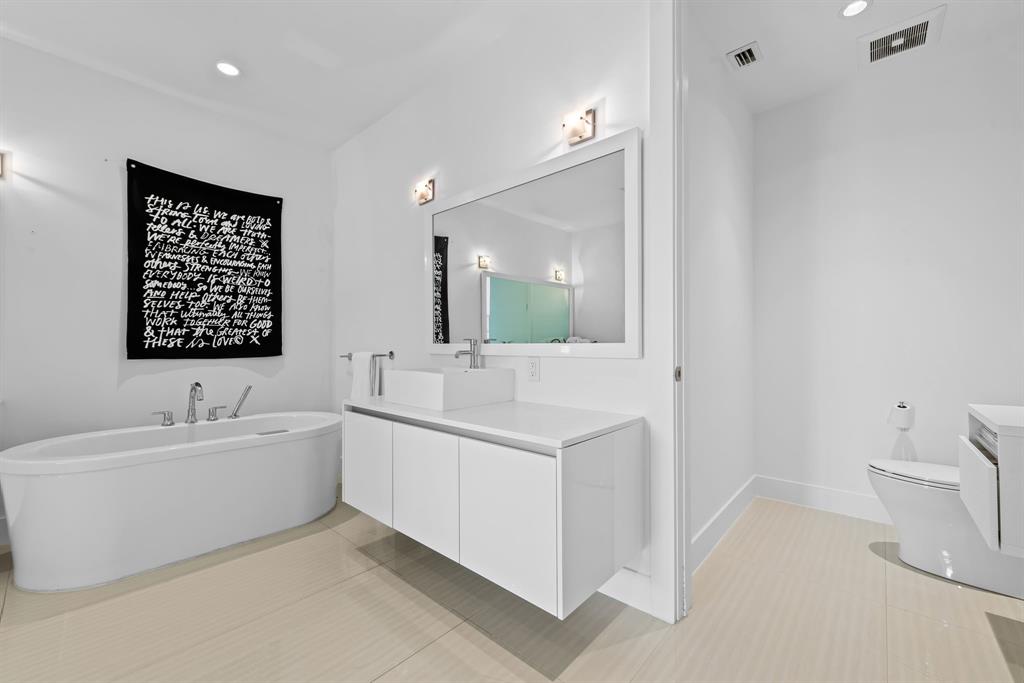 60 Hendricks Isle, Unit 301 Fort Lauderdale, FL 33301 - Photo 13 of 31 a spacious bathroom with a double vanity sink toilet mirror and bathtub
