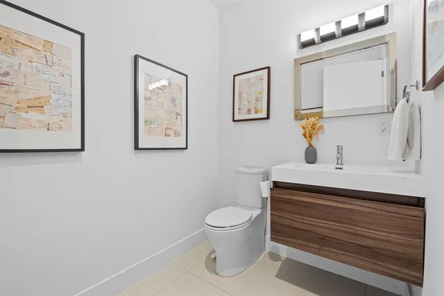 a bathroom with a toilet a sink and a mirror