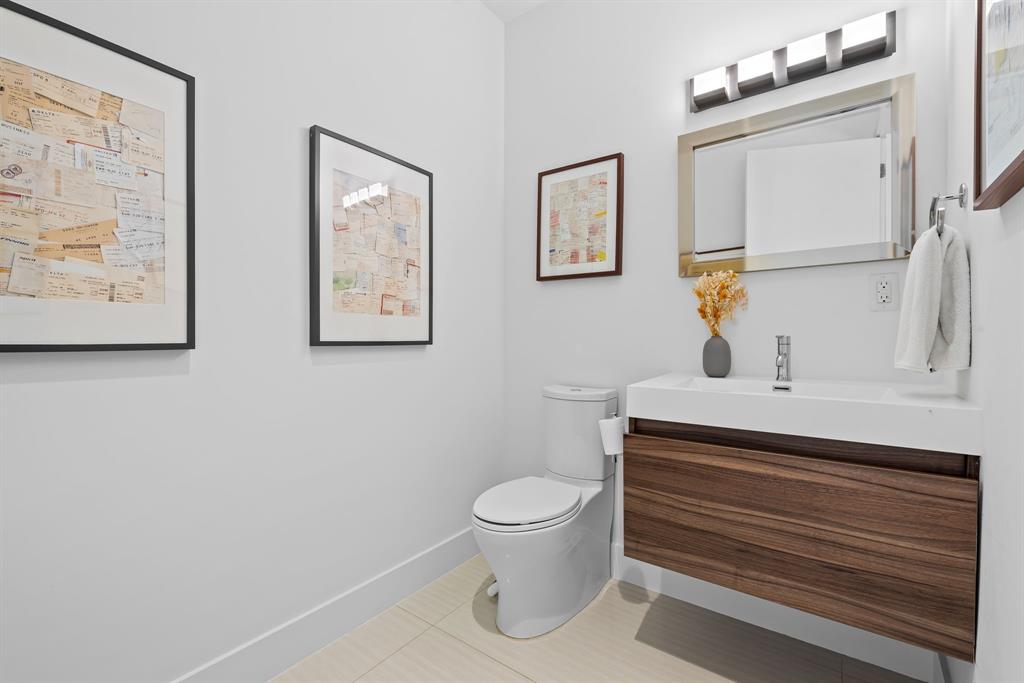 60 Hendricks Isle, Unit 301 Fort Lauderdale, FL 33301 - Photo 17 of 31 a bathroom with a toilet a sink and a mirror