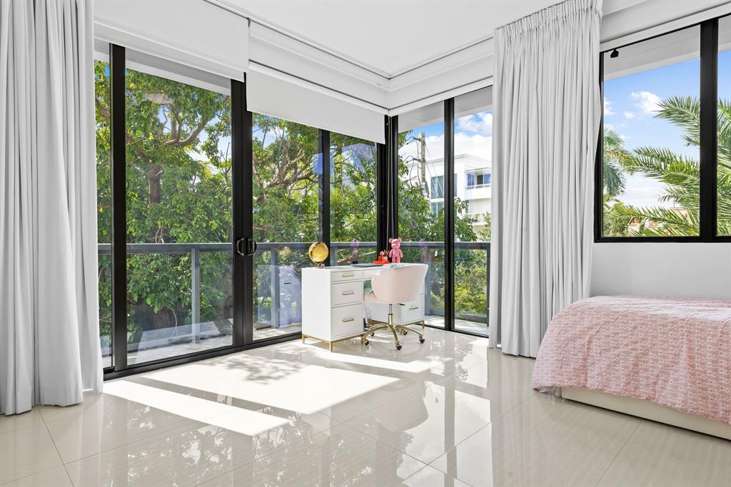 60 Hendricks Isle, Unit 301 Fort Lauderdale, FL 33301 - Photo 18 of 31 a bedroom with a bed and large windows