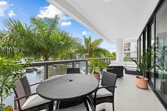 a view of a chairs and table in the balcony