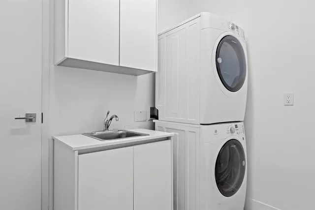a utility room with sink dryer and washer