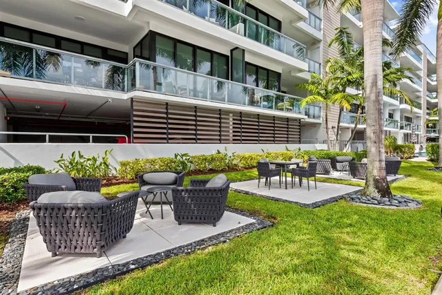 a view of a patio with a table and chairs