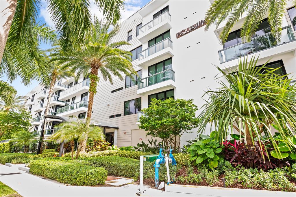 60 Hendricks Isle, Unit 301 Fort Lauderdale, FL 33301 - Photo 31 of 31 a front view of a multi story residential apartment building with yard and green space