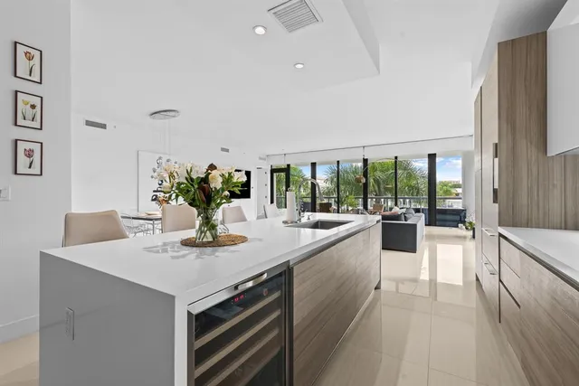 a dining hall with stainless steel appliances a large window and a counter space