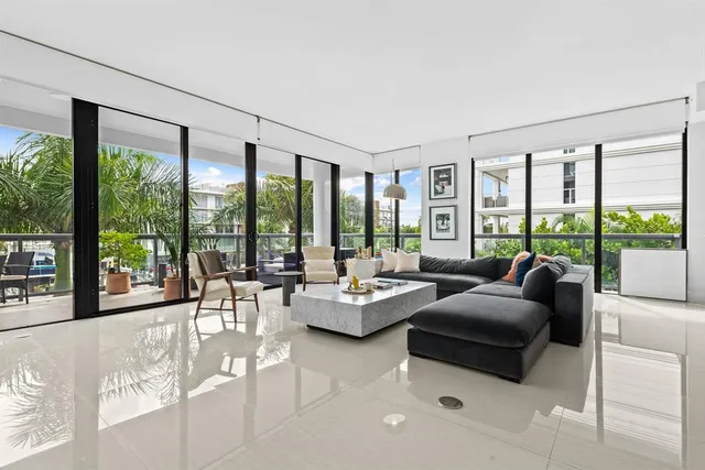 a living room with furniture and large windows