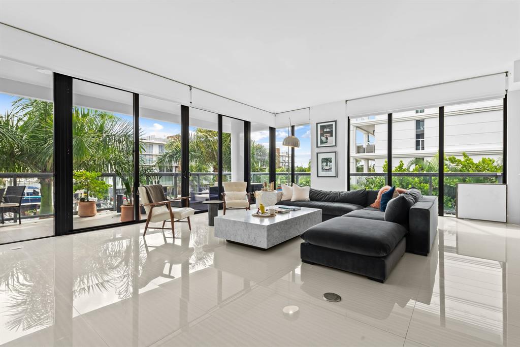 60 Hendricks Isle, Unit 301 Fort Lauderdale, FL 33301 - Photo 6 of 31 a living room with furniture and large windows