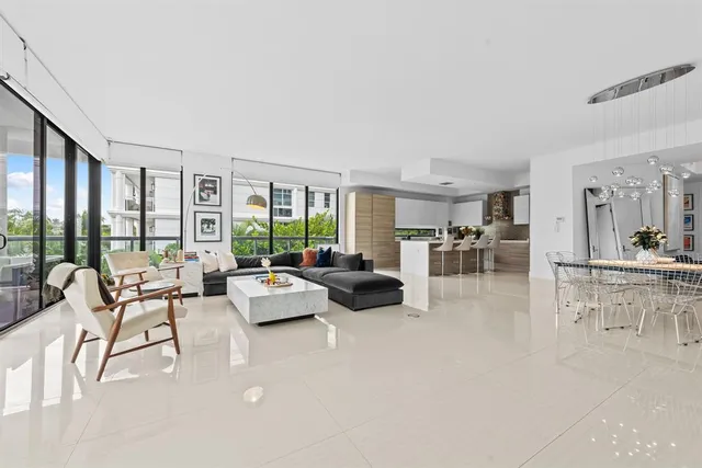 a living room with furniture and large windows