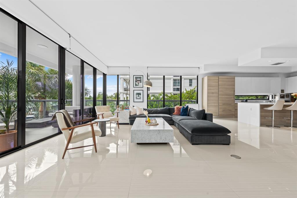 60 Hendricks Isle, Unit 301 Fort Lauderdale, FL 33301 - Photo 8 of 31 a living room with furniture and large windows