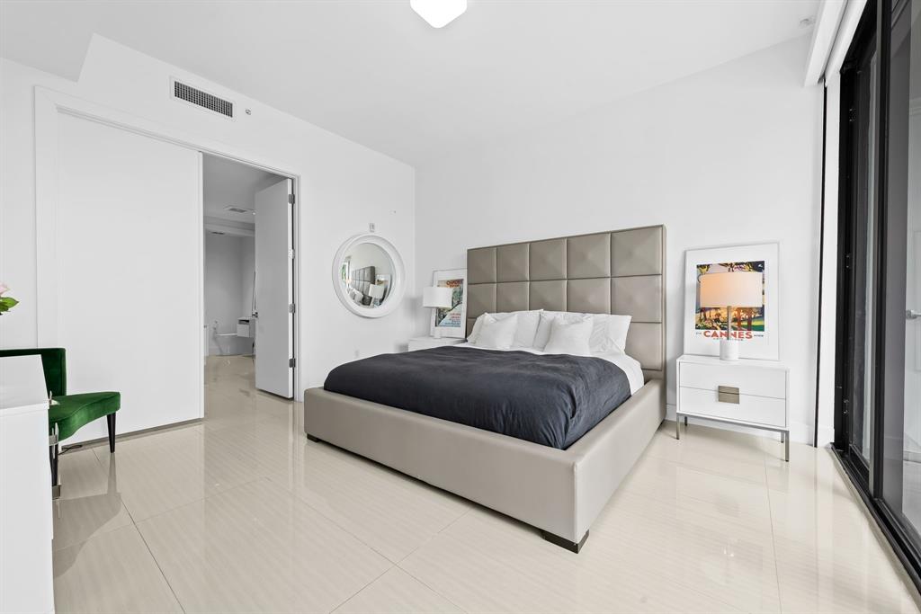 60 Hendricks Isle, Unit 301 Fort Lauderdale, FL 33301 - Photo 9 of 31 a bedroom with a bed and a cabinets