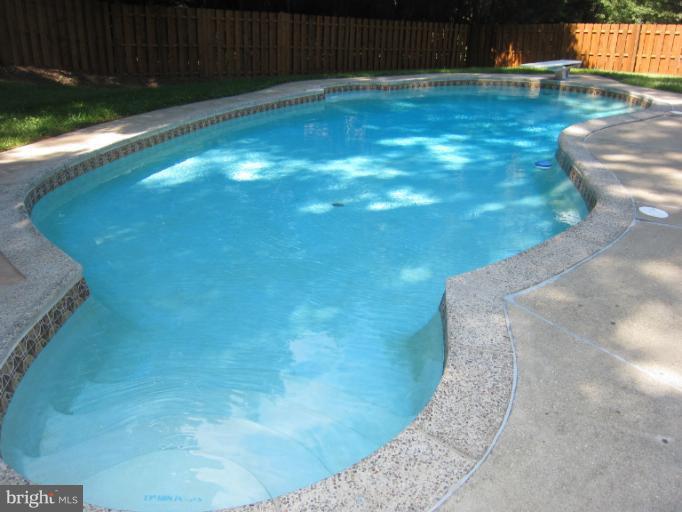 14905 Wellwood Road Silver Spring, MD 20905 - Photo 26 of 30 Inviting in-ground pool w/ patio surround, hot tub