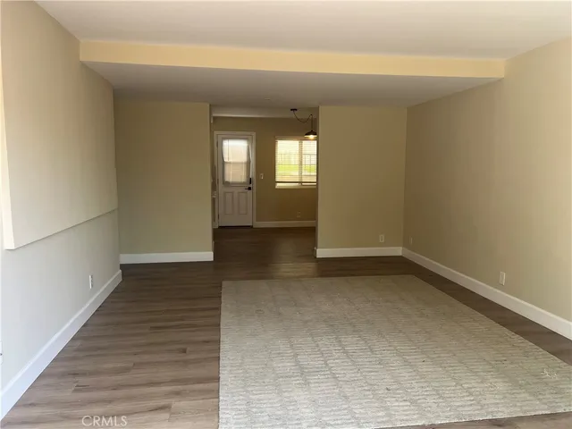 a view of kitchen with refrigerator and cabinets