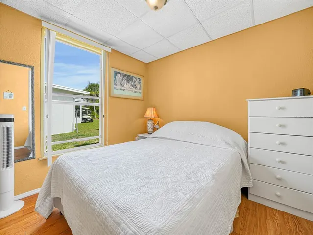 a bedroom with a bed and a mirror