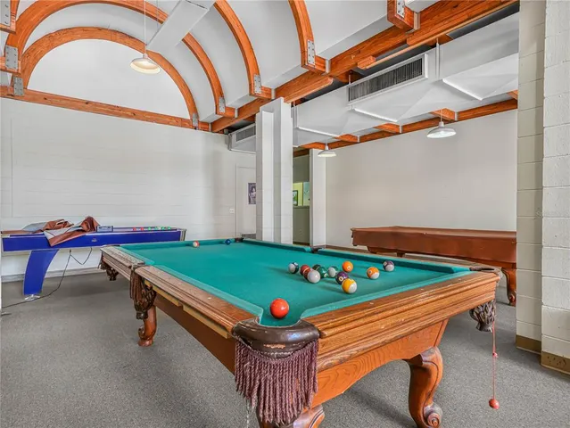 a room with pool table and windows